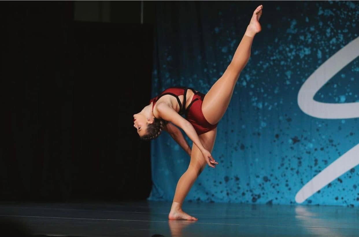 DPAC dancer performing a competition solo in maroon