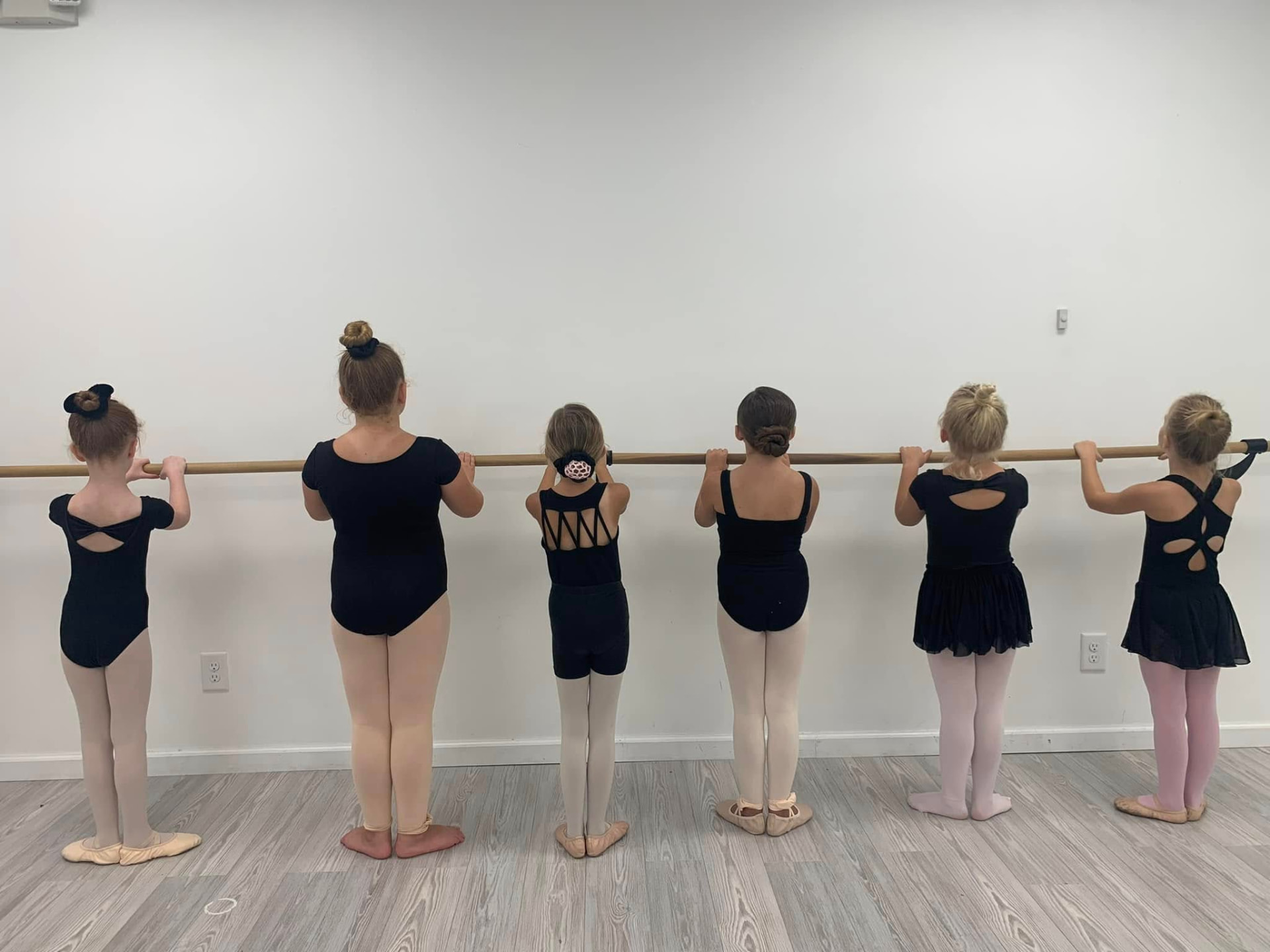 Young ballet students lined up at the barre during class