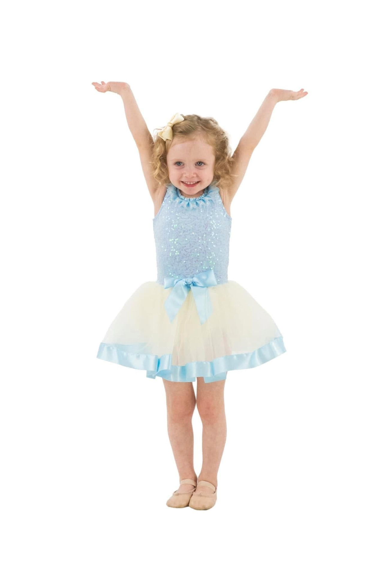 A dancer holding a high vertical kick under recital lighting